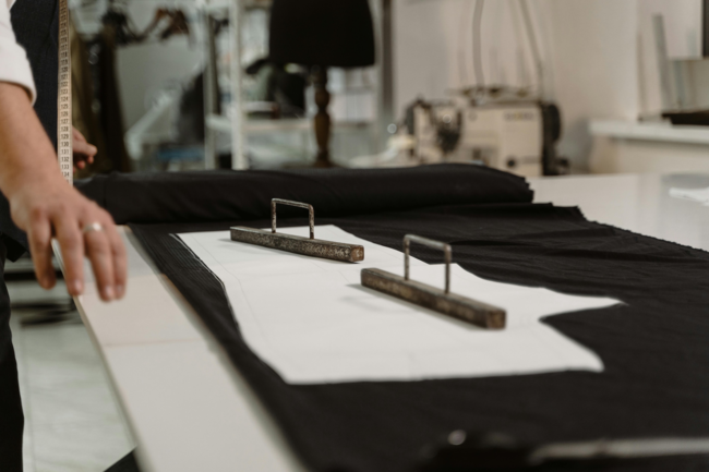 A woman weighing down fabric ready to cut