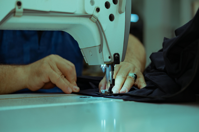 a close up of a woman stitching