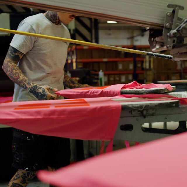 A man decorating a W101 Tote Bag